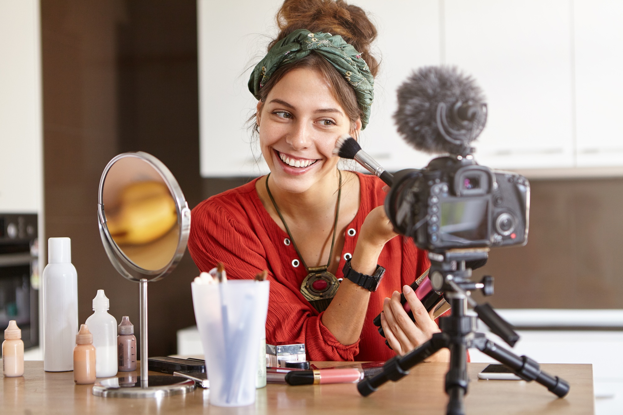 People, beauty, fashion and style concept. Portrait of positive joyful young female vblogger recordi